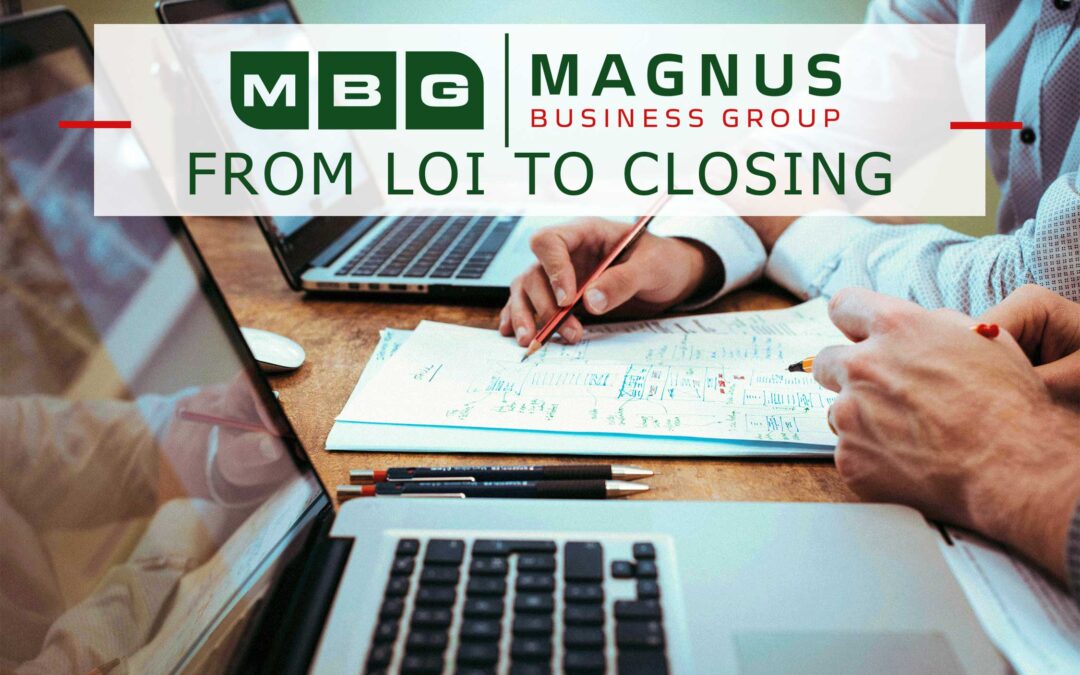 Business professionals reviewing due diligence documents after an LOI in a business sale.